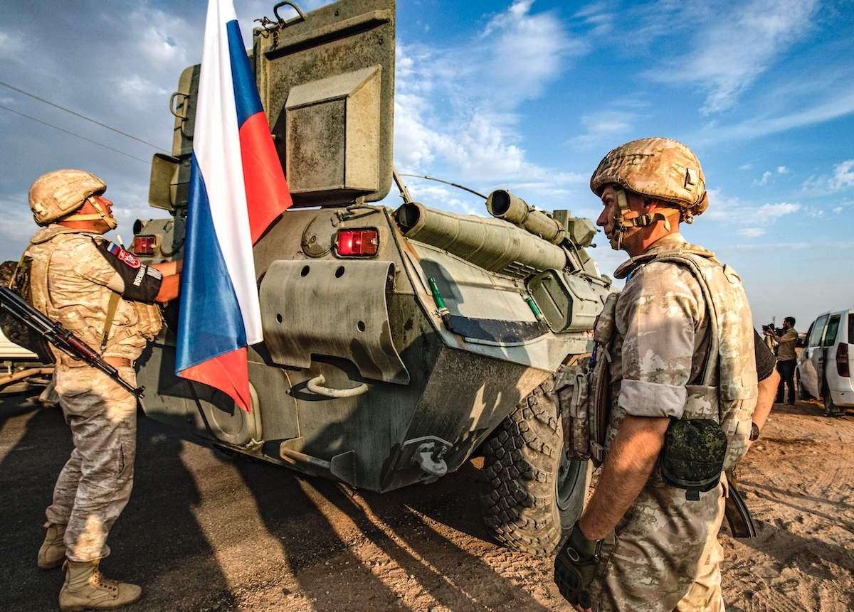 Russian military police stand outside an armored personnel carrier near the northeastern Syrian town of Amuda in 2019. |